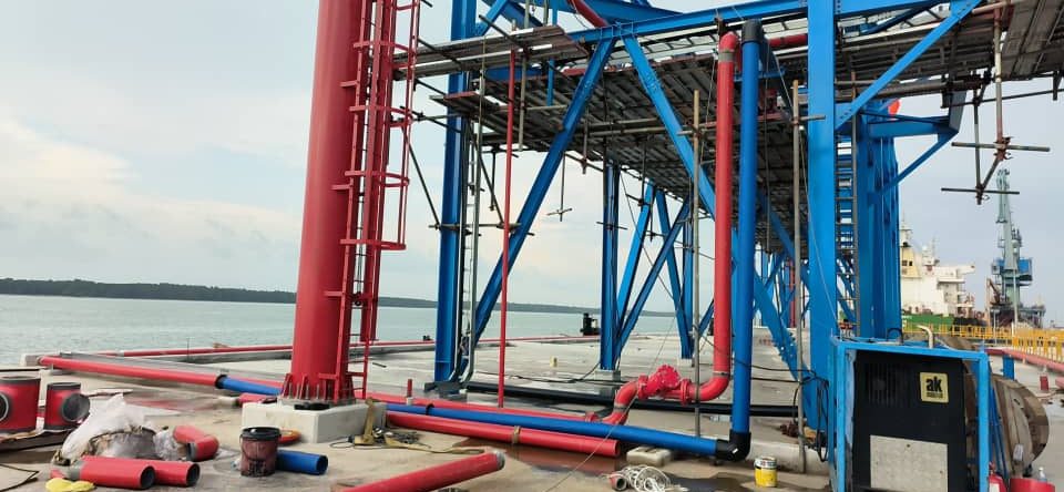 Red and blue firefighting pipework on a jetty structure